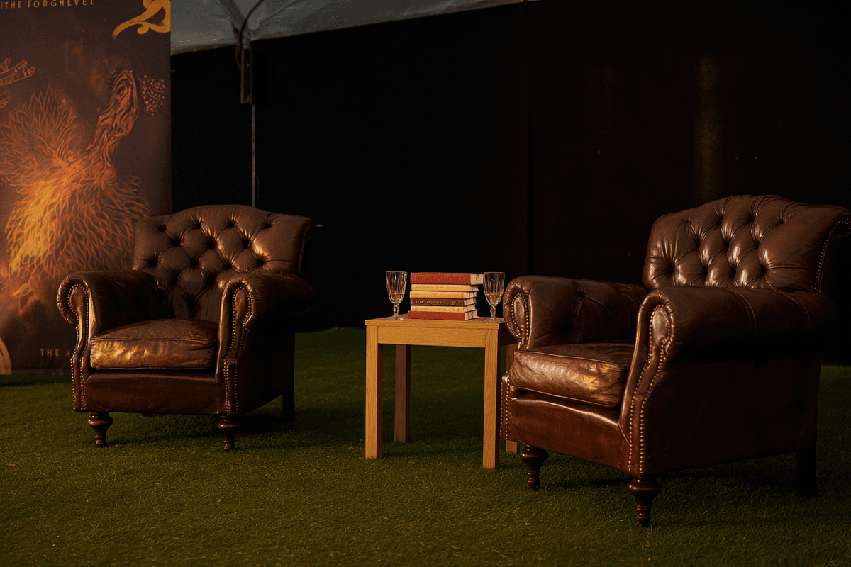 Empty leather chairs on a festival stage waiting to be filled